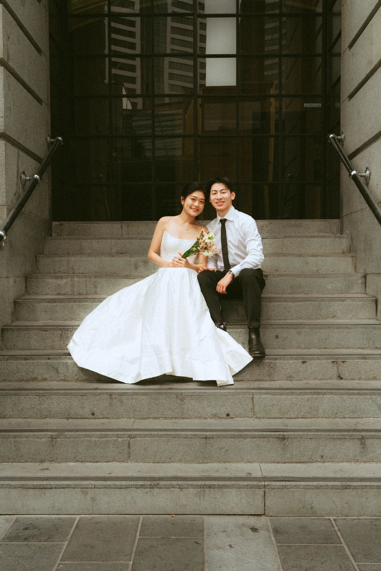 Emily and Benny sitting together on stone steps