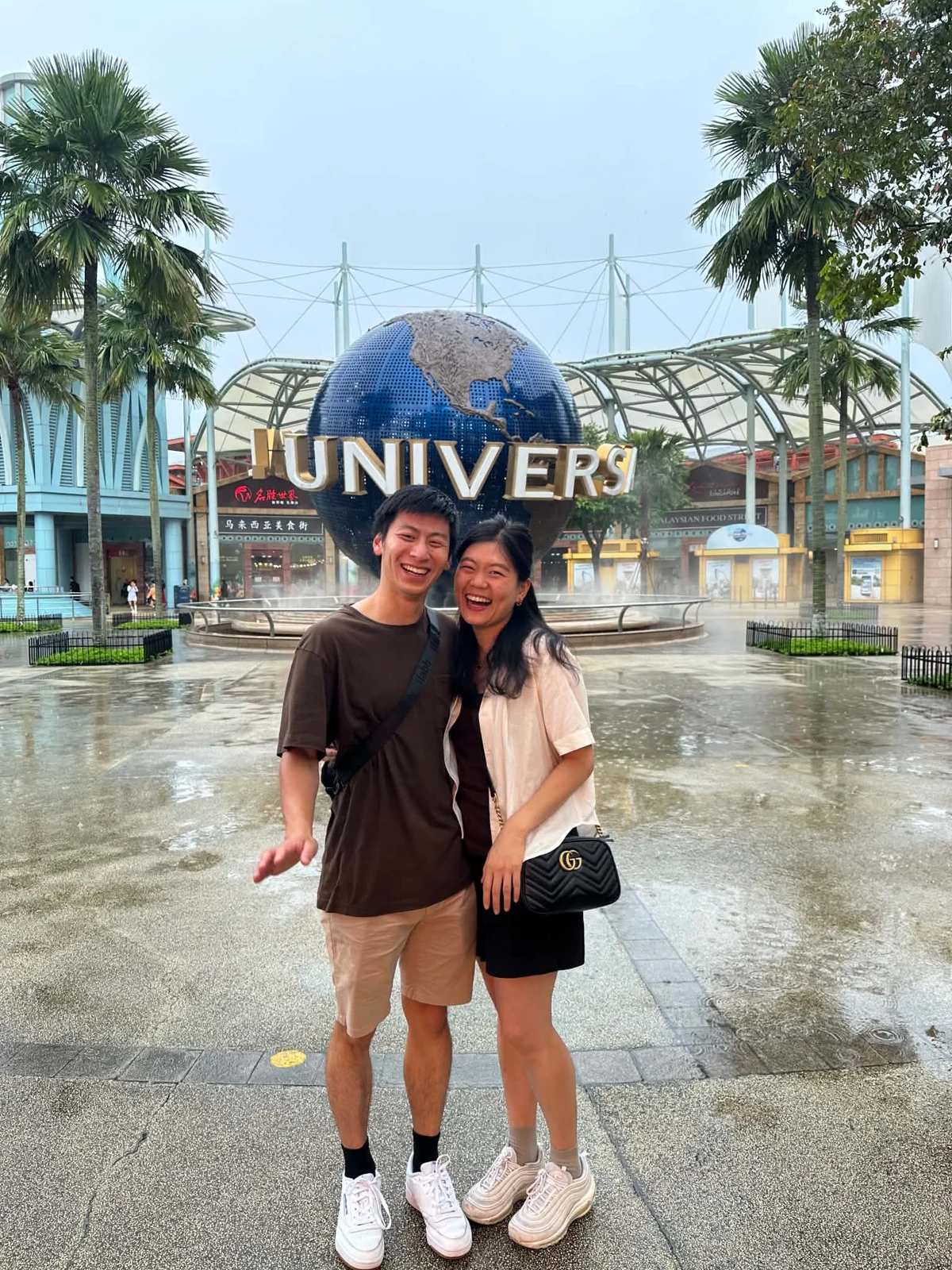 Emily and Benny smiling in front of the Universal Studios globe