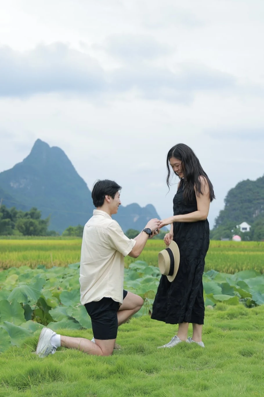 Emily and Benny sharing their proposal surrounded by green fields and mountains